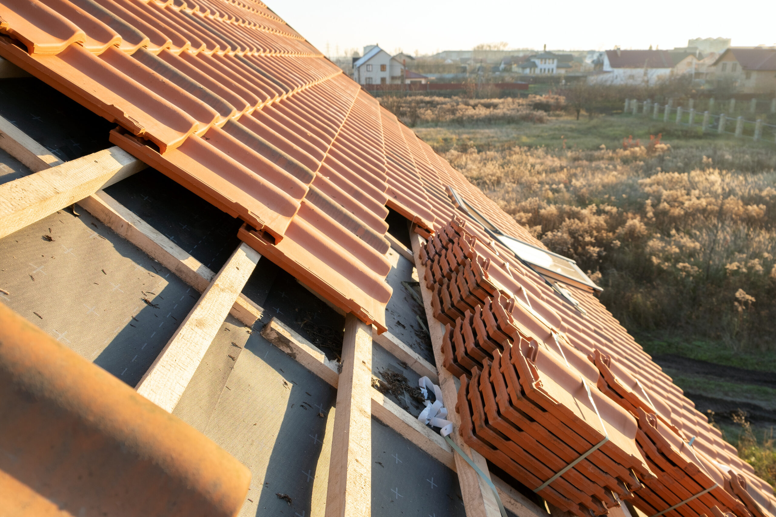 Stacks of yellow ceramic roofing tiles for covering residential